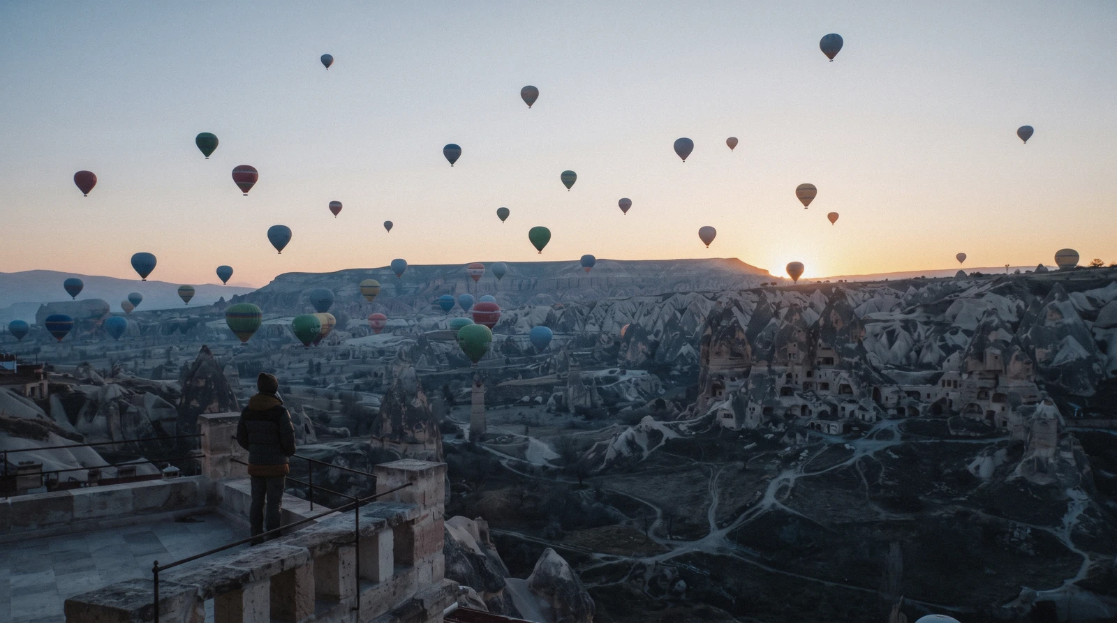 Hot air balloons over the fairy chimneys of Cappadocia on a trip from Istanbul, Türkiye